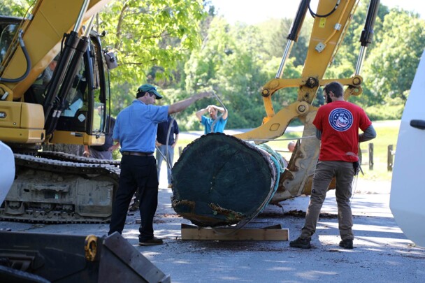 Plimoth patuxet museum staff moving mishoon log