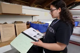 Educator holds old manual