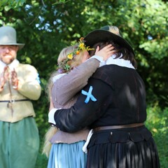 The Pilgrim bride and groom embrace after they are married.