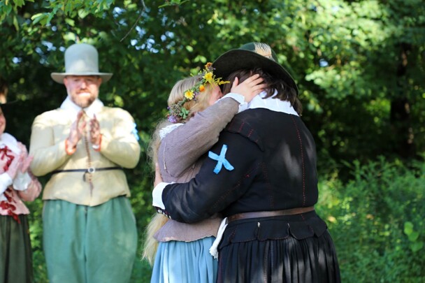 The Pilgrim bride and groom embrace after they are married.