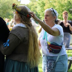 A Museum guest adjusts the Pilgrim Bride's flower crown.