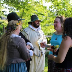 Museum guests gather to speak with Pilgrim Bride and Groom.