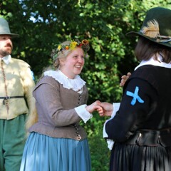 Pilgrim bride and groom join hands during wedding ceremony.