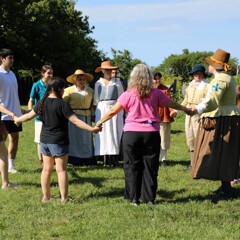 Guests and Pilgrims join hands in a circle.