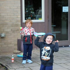 Two children play catch outside of the Museum's Craft Center.