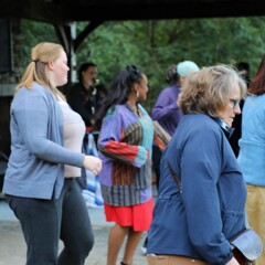 A group of women dance at The GroovaLottos play live music.