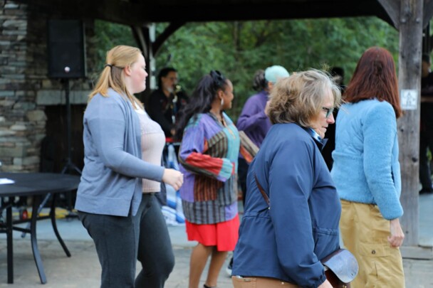 A group of women dance at The GroovaLottos play live music.