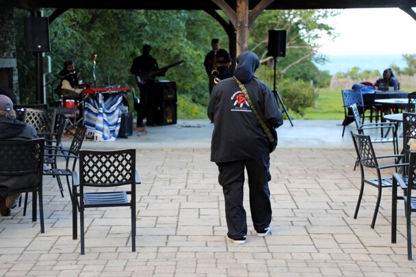 The Lead singer of The GroovaLottos walks amongst the auidence as he peforms.