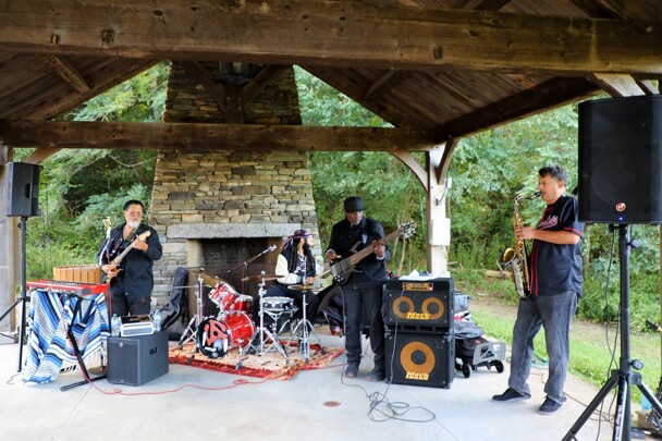 The lead singer, drummer, guitarist, and saxophone player of The GroovaLottos perform at Plimoth Patuxet Museums.