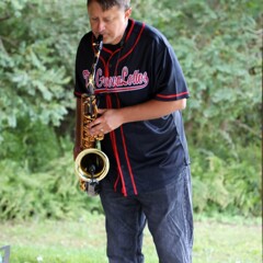 A member of The GroovaLottos plays the saxophone.
