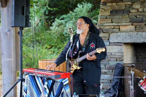Lead singer of The GroovaLottos balnces playing the guitar and the keyboard.