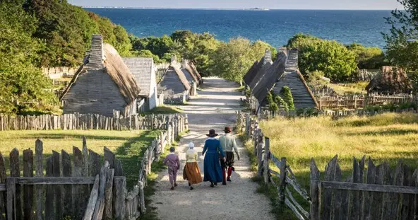 Pilgrim family walks down main path of the 17th-Century English Village