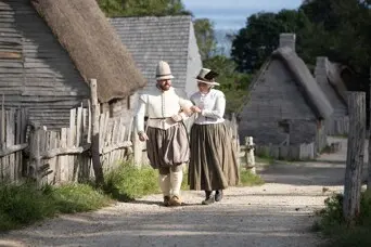 Pilgrim couple walks down village path