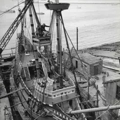 Men work on Mayflower at dock