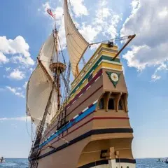 Tall ship under sail seen from behind