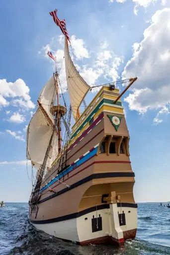 Tall ship under sail seen from behind