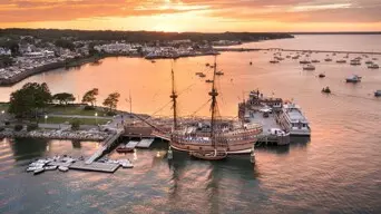Ariel view of Mayflower II docked in downtown Plymouth at sunset