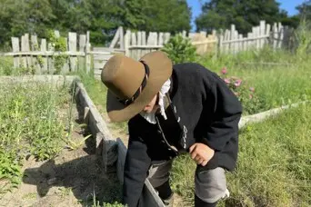 pilgrim man works in garden