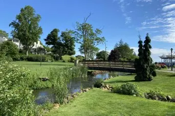 bridge over a brook in a grassy field