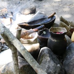 Wampanoag cooking pot set over a fire outdoors
