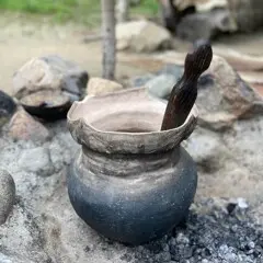 A Wampanoag cooking pot set in an outdoor cooking arbor