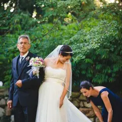 A bride prepares to walk down the aisle in a garden