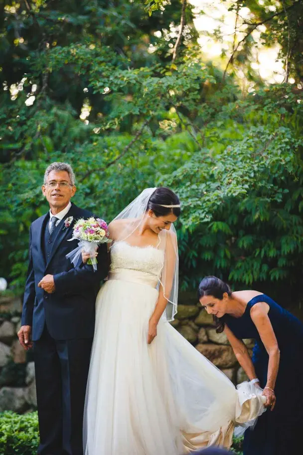 A bride prepares to walk down the aisle in a garden