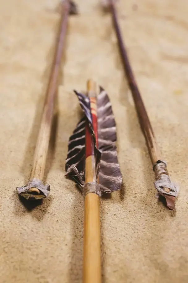 Three brass pointed arrows on a fur.