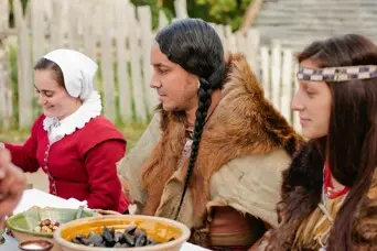 Wampanoag People share a feast with Pilgrims