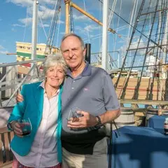 Guests pose on the exhibit docks in front of Mayflower II.