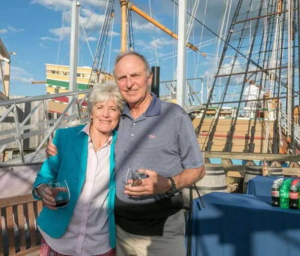 Guests pose on the exhibit docks in front of Mayflower II.